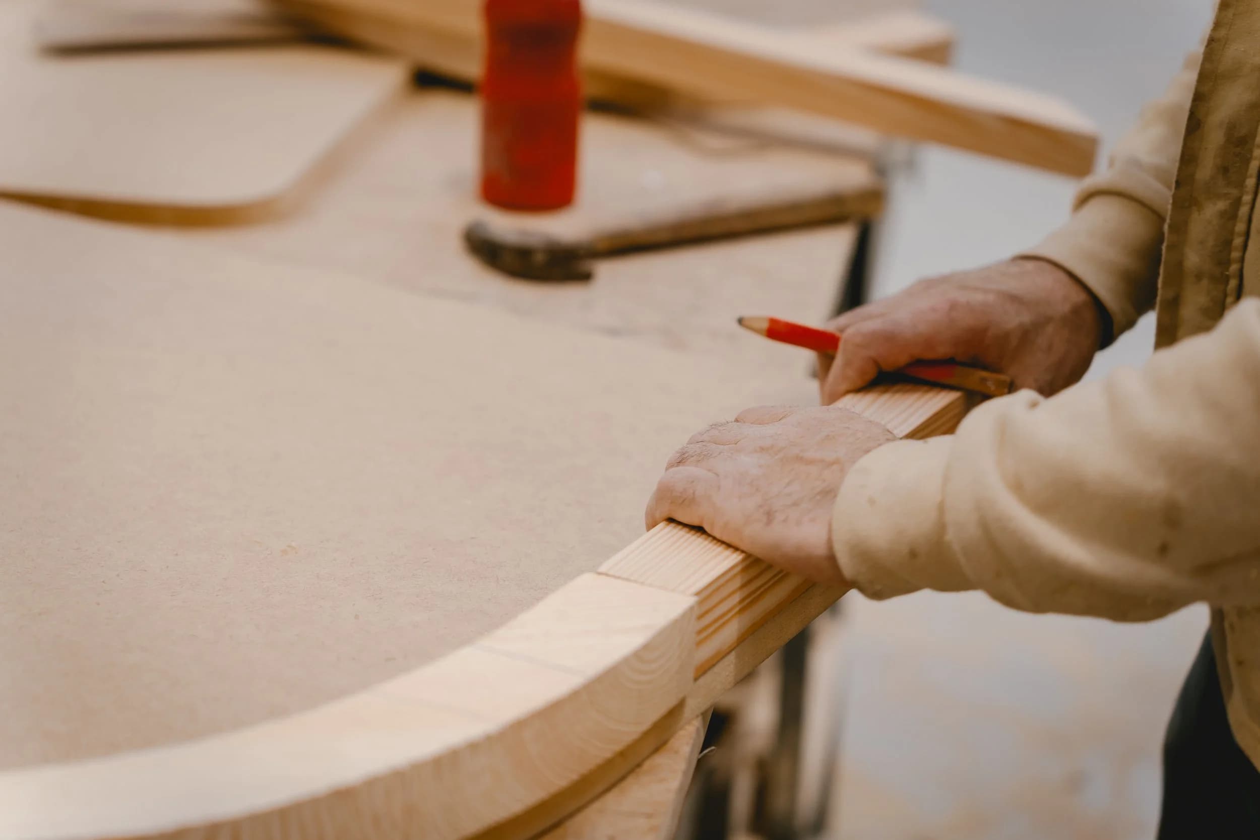 Hand-finishing a solid timber piece in the Elbra workshop