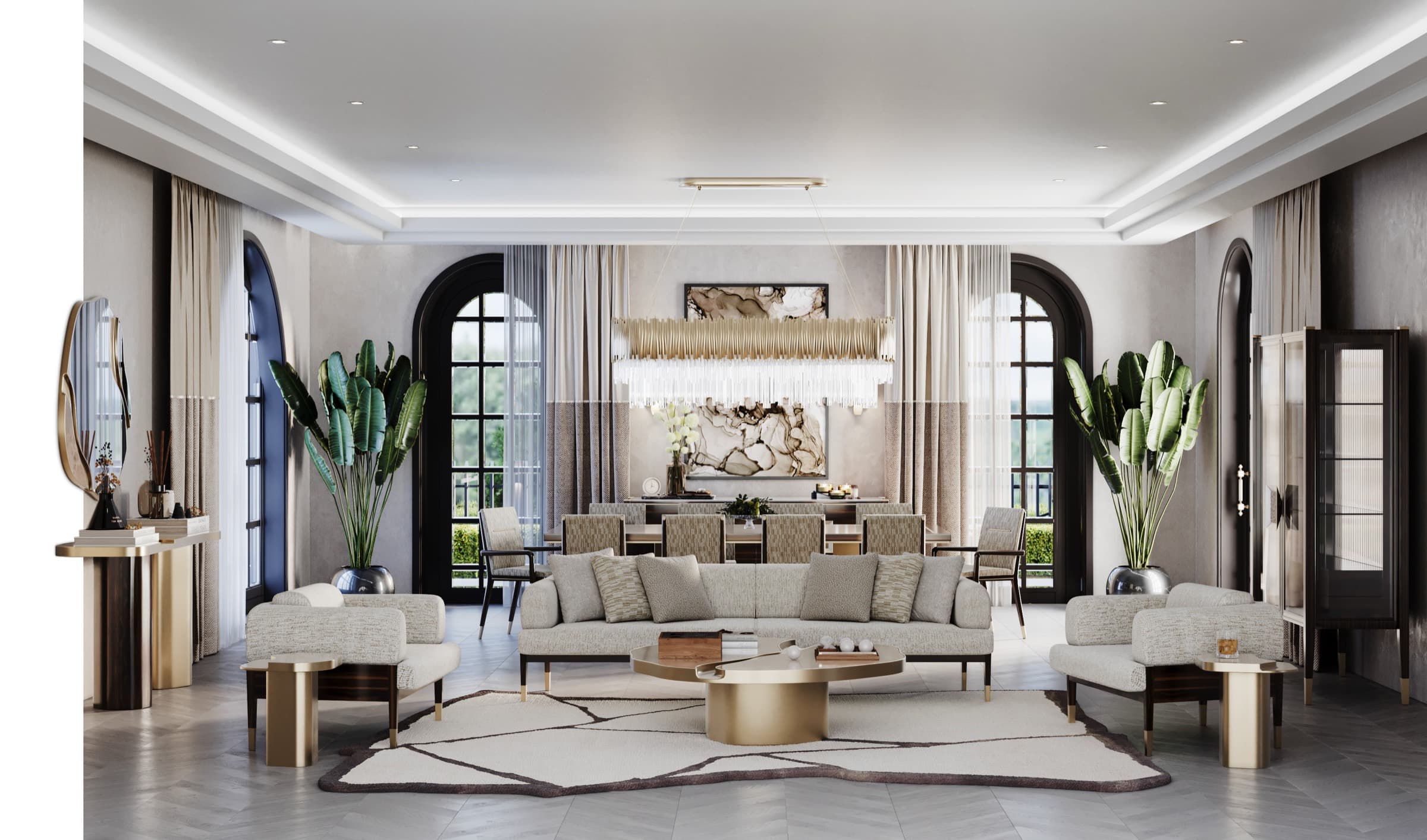 Sienna living room — a symmetrical formal drawing room with pale tweed seating around a round brass-and-stone table beneath a tiered brass chandelier