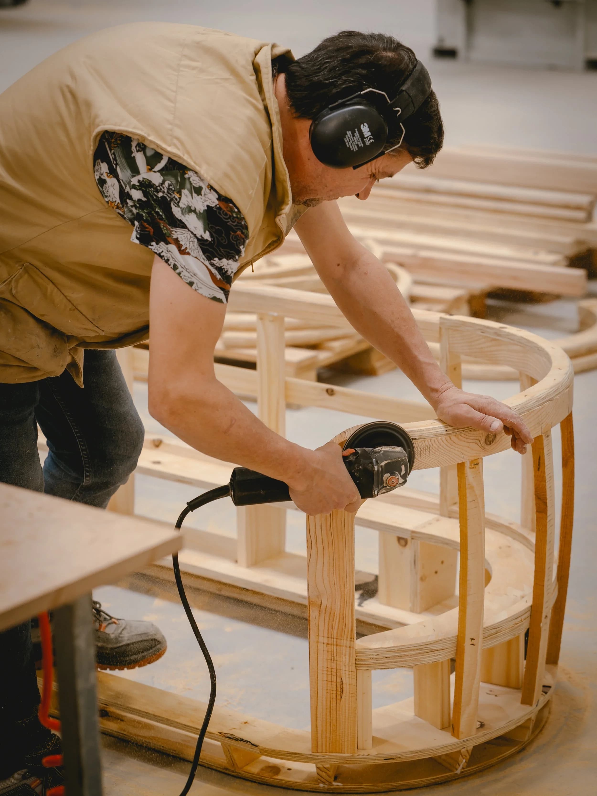 Hand-sanding a furniture frame to finish