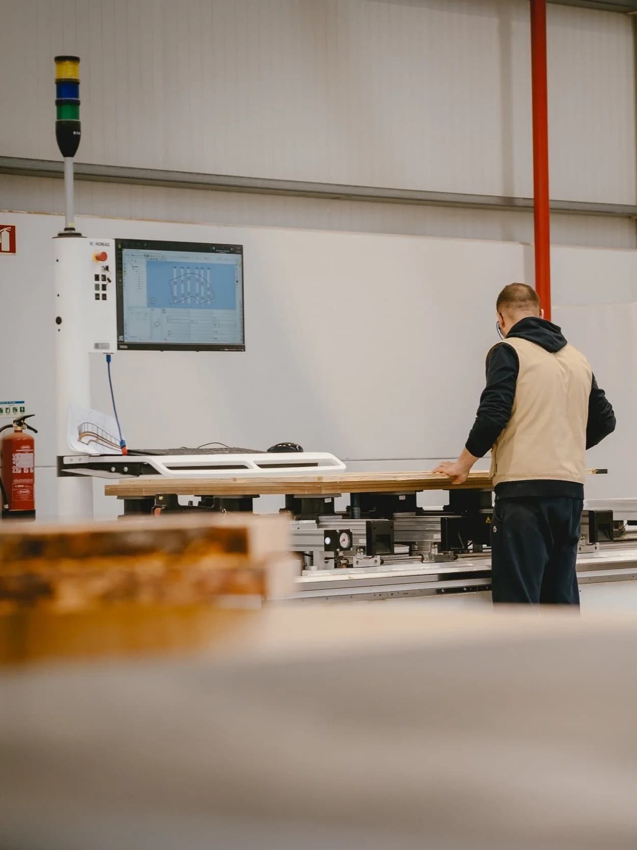 A craftsman inspecting solid timber in the Elbra workshop