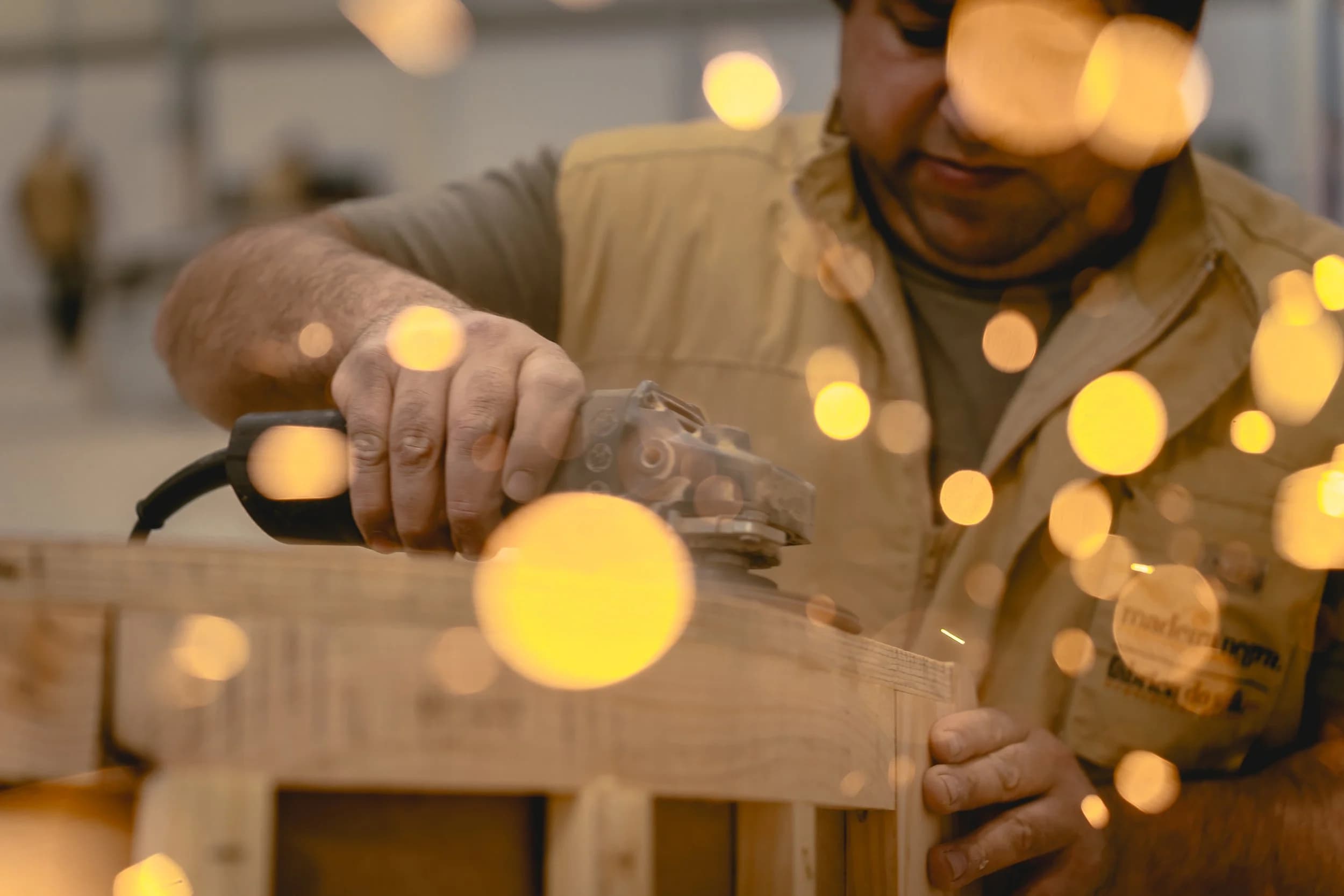 Artisan hand-finishing solid timber in the Elbra workshop